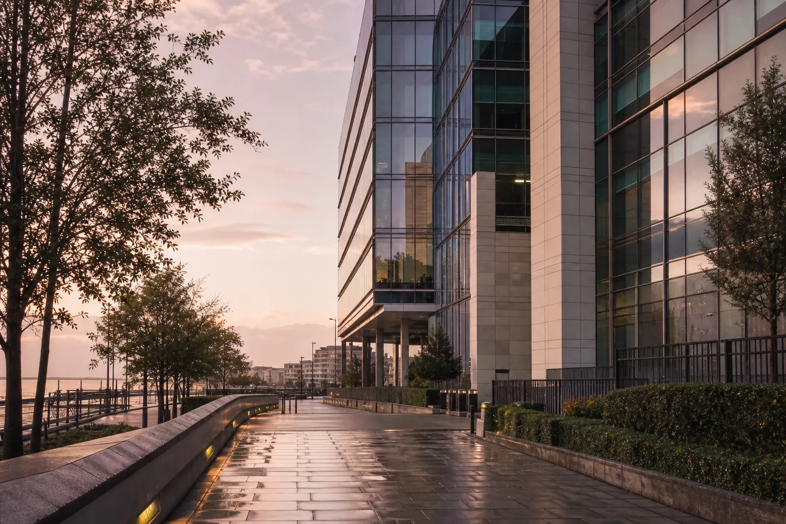 Modern glass office building approach in Brighton after rain